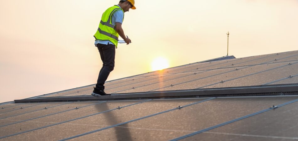 Man,in,a,yellow,vest,is,working,on,a,solar